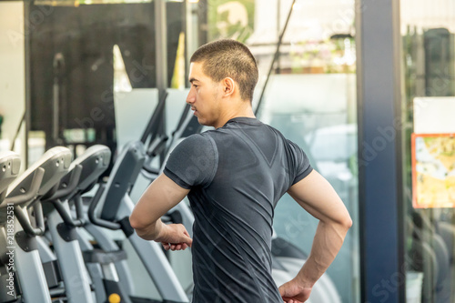 Young sport man exercising in fitness gym