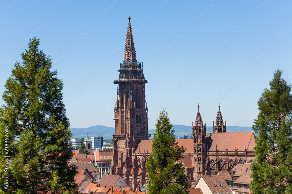 Fototapeta premium Freiburg cathedral tower against blue sky, Germany