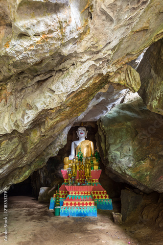 Several Buddha statues on altar inside the Tham Hoi Cave near Vang Vieng, Vientiane Province, Laos.