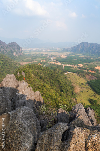 Scenic view of Vang Vieng and the surrounding area from above from the Phangern (Pha Ngern, Pha ngeun) mountain in Laos on a sunny day. photo