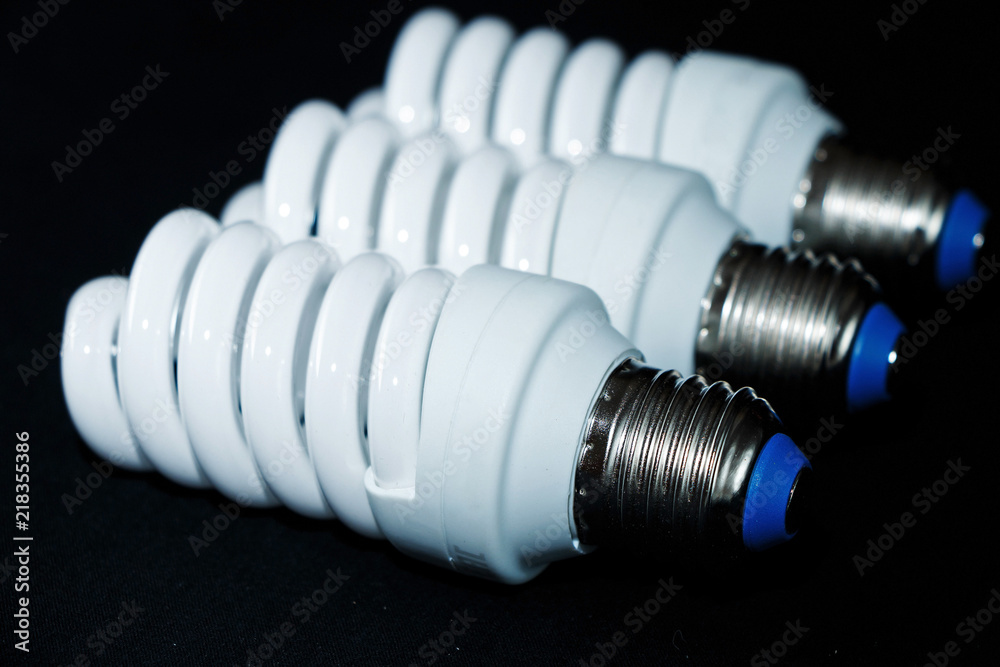 Electric white lightbulbs in the form of spirals on a black background. Electric white lightbulbs in the form of spirals on a black background.