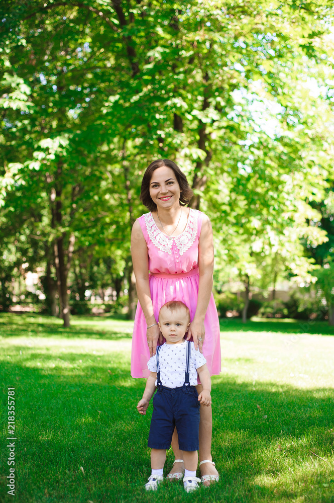 Fototapeta premium Happy young family spending time together outside in green nature.