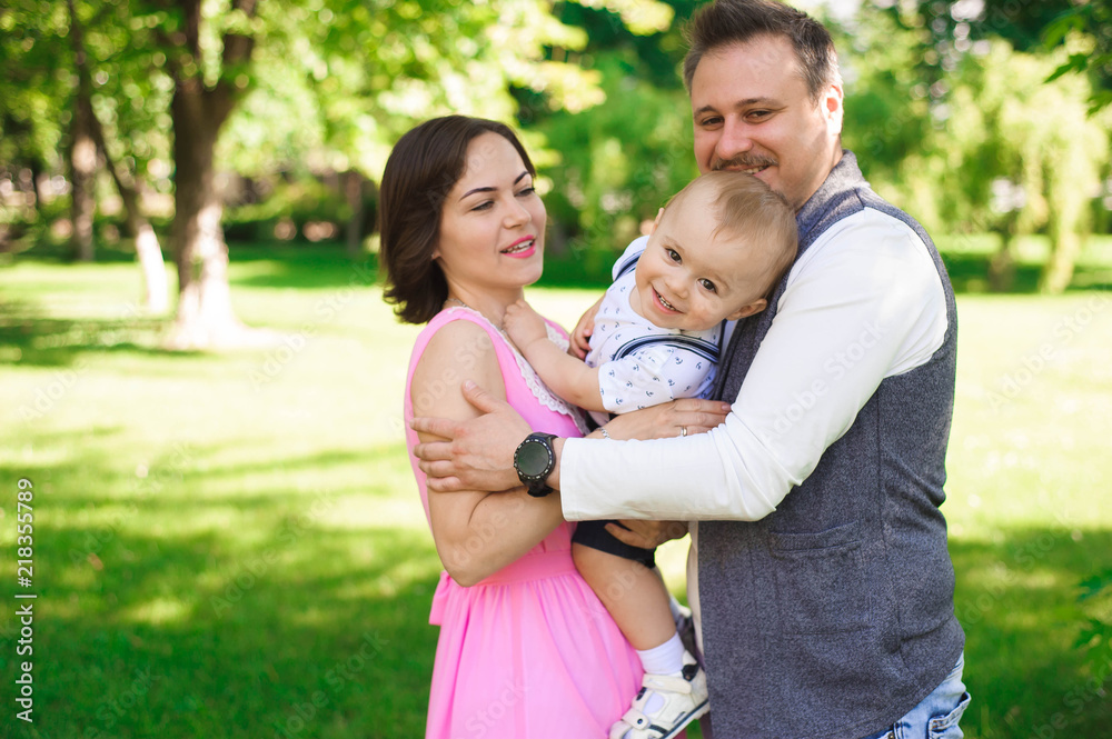 Happy young family spending time together outside in green nature. Happy young family spending time together outside in green nature.