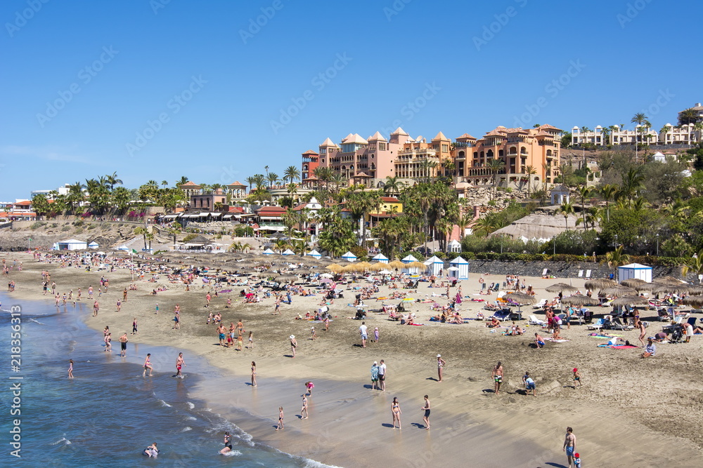 Tourists on El Duque beach in Costa Adeje, Tenerife, Spain Tourists on El Duque beach in Costa Adeje, Tenerife, Spain