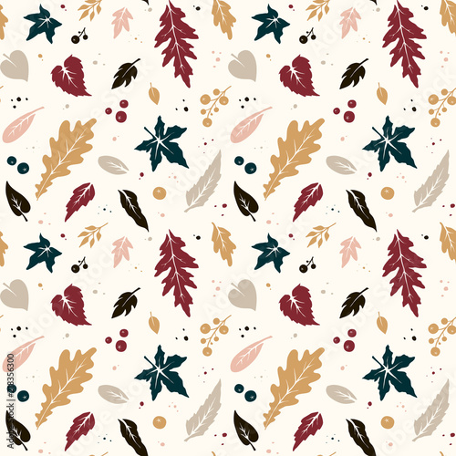 Seamless hand-drawn autumn pattern from leaves and berries