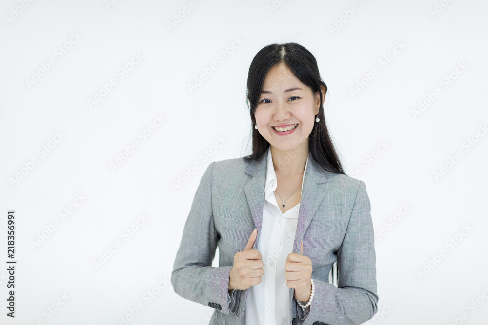 Beautiful Asian girl with long hair looks good smil wearing a suit. Standing on a white background, studio shot. Beautiful Asian girl with long hair looks good smil wearing a suit. Standing on a white background, studio shot.