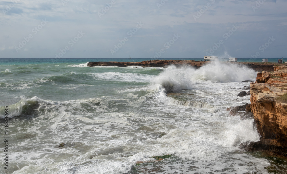 White ocean waves crashing to rocks