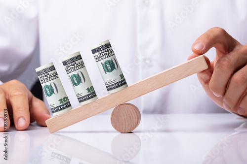 Εκτύπωση καμβά Person Balancing Currency Notes On Seesaw