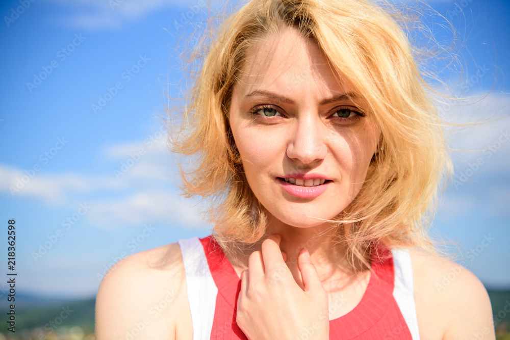 Girl pleased with warm sunlight looks relaxed blue sky background. Take care skin put sunscreen cosmetics. Bleached hair summer care. Woman blonde relaxing outdoors. Take care about your wellbeing Girl pleased with warm sunlight looks relaxed blue sky background. Take care skin put sunscreen cosmetics. Bleached hair summer care. Woman blonde relaxing outdoors. Take care about your wellbeing