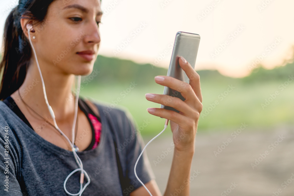 Young woman listening music outside