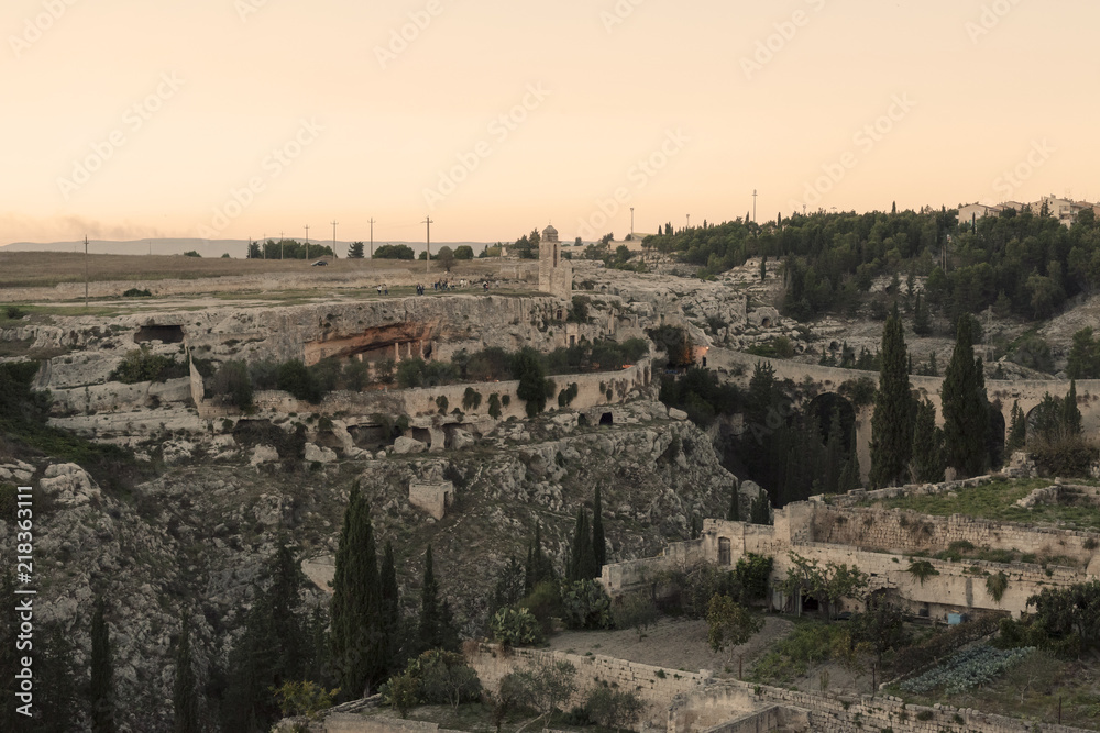 A view of the old town of Gravina in Puglia, Italy, at sunset.
