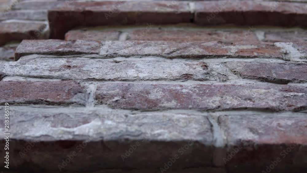 Old wall with ancient crumbling brickwork, you can see the structure of the bricks. The camera is directed upwards and moves from left to right. Old wall with ancient crumbling brickwork, you can see the structure of the bricks. The camera is directed upwards and moves from left to right.