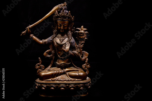 Decorative buddhistic sculpture on a black background