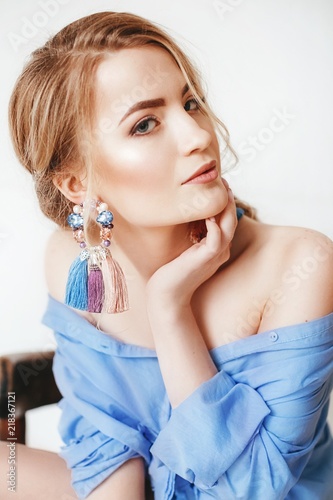 Portrait of beautiful young blonde woman in exquisite jewelry. Fashion photo