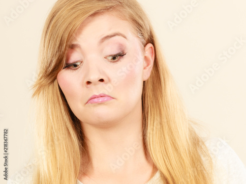 Sad cute young blonde attractive woman