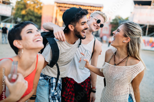 Happy friends having fun at music festival