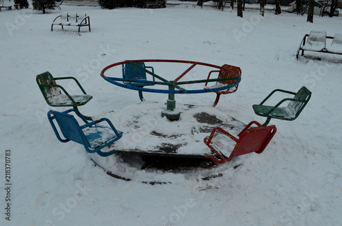 creepy old shabby children's swing from the horror movie, winter dusk