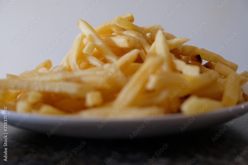 Fries on plate on counter Fries on plate on counter