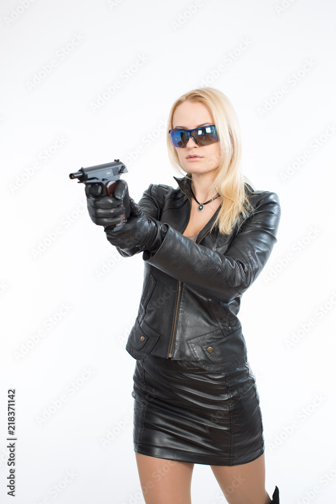 Young woman in sunglasses and a gun Young woman in sunglasses and a gun