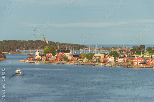 One of the many fishing towns in Sweden. A cozy Scandinavian town with red houses. Soft sunny golden light.