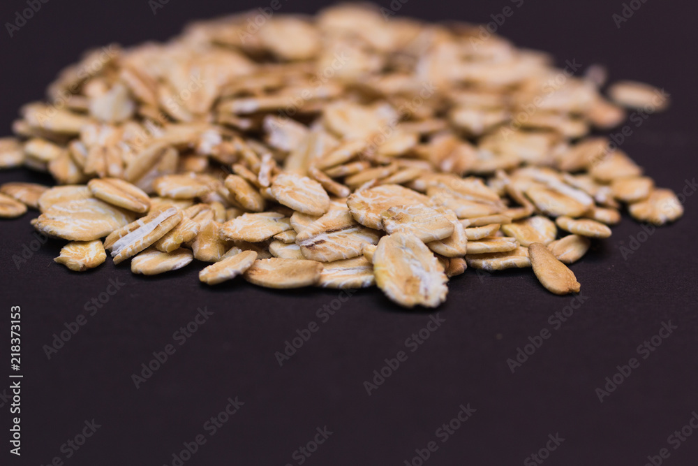 Close-up of oat flakes on black background
