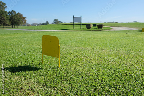 Little Yellow sign on a golf course photo
