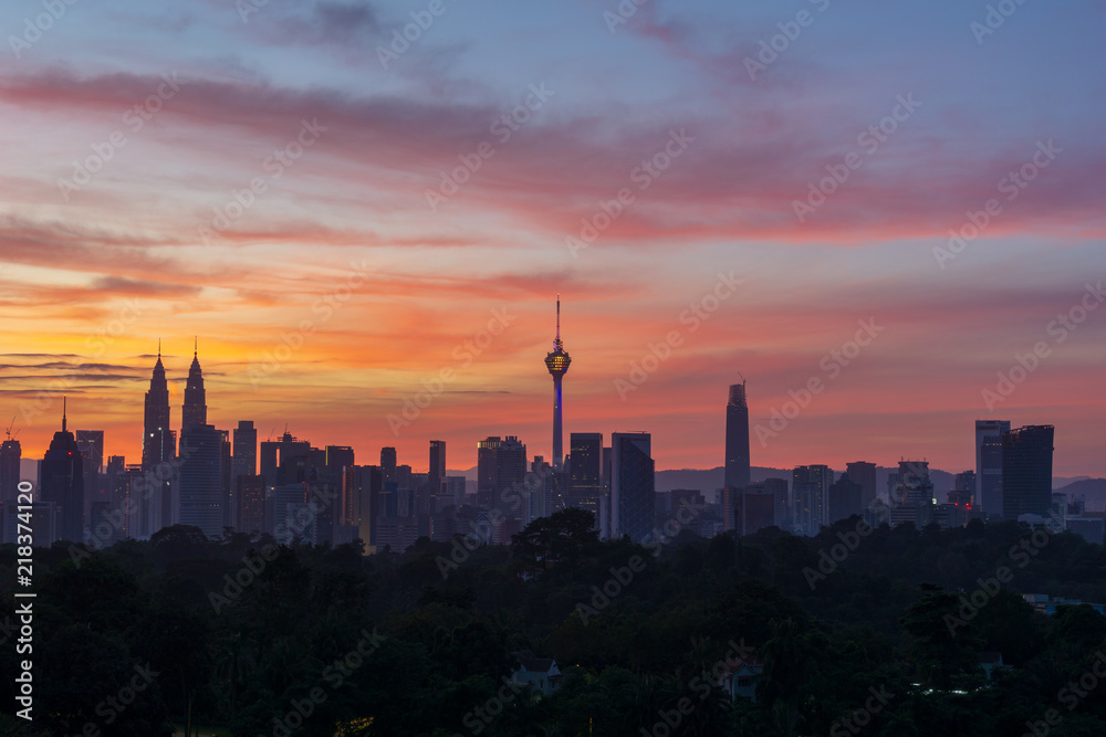 KUALA LUMPUR, MALAYSIA - 12th AUG 2018; Majestic sunset over Twin Towers and surrounded buildings in downtown Kuala Lumpur, Malaysia.