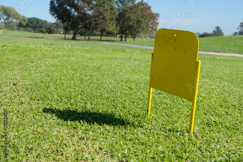 Little Yellow sign on a golf course photo