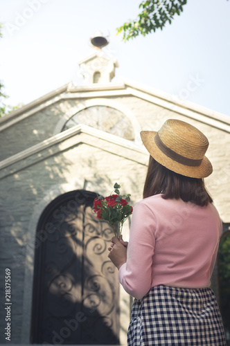 Woman standing in front of church. © peerayot