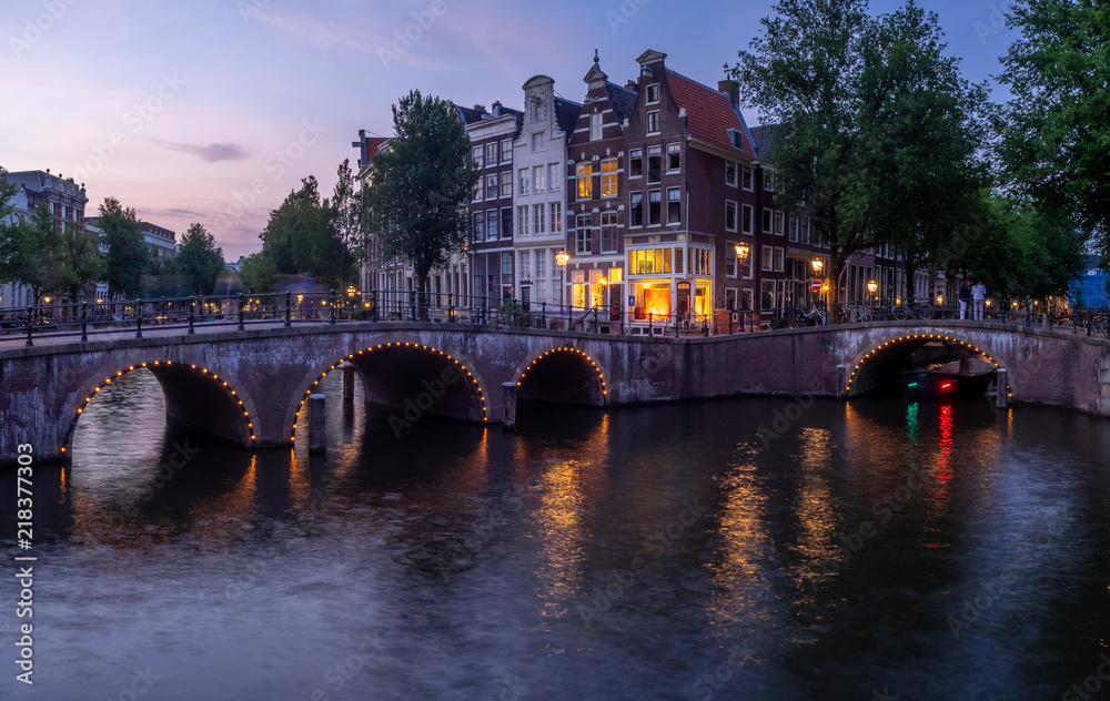 Bridge over Keizersgracht - Emperor's canal in Amsterdam, The Netherlands at twilight.