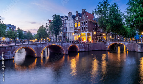 Bridge over Keizersgracht - Emperor's canal in Amsterdam, The Netherlands at twilight.