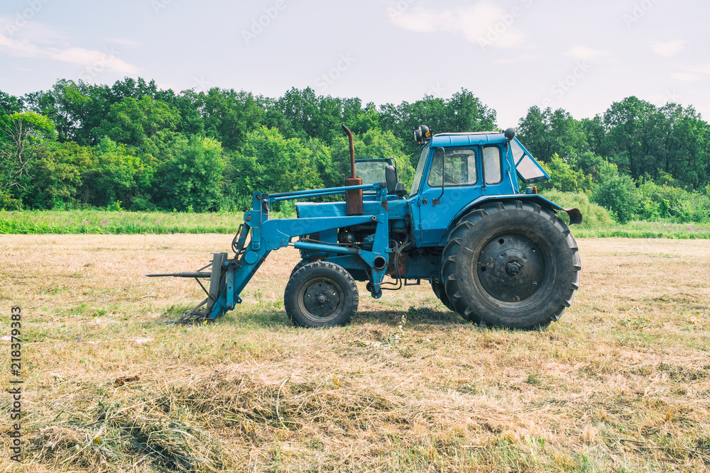 Tractor for working in the field and mowing grass Tractor for working in the field and mowing grass
