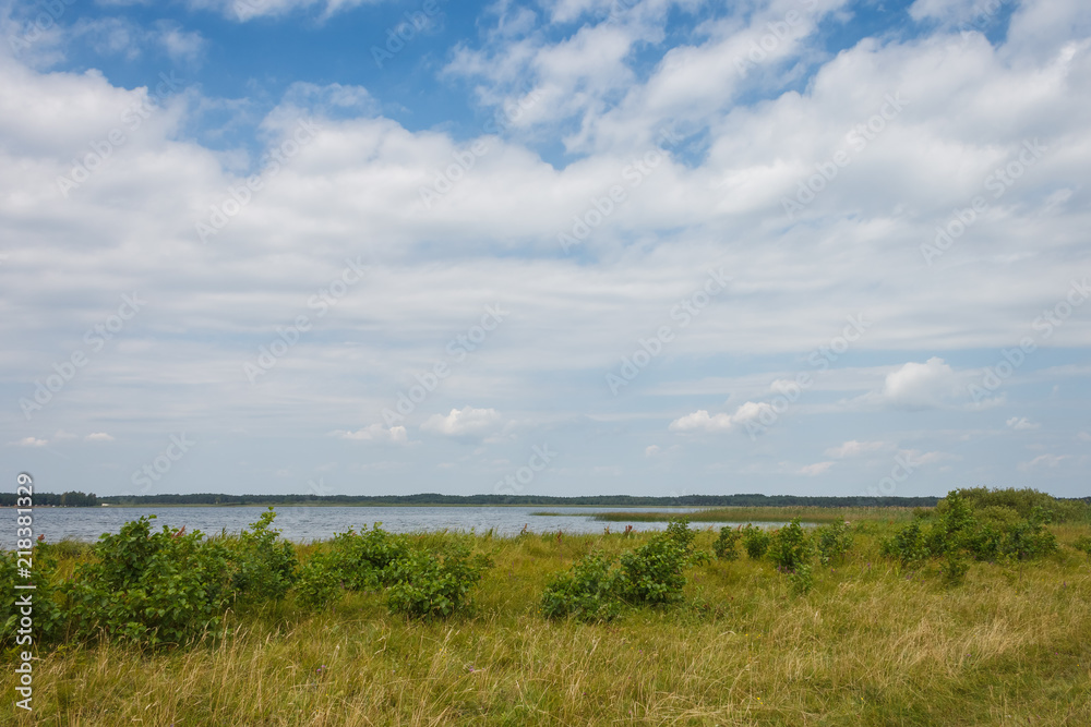 Lake on a sunny day with blue sky and white clouds. Lake on a sunny day with blue sky and white clouds.