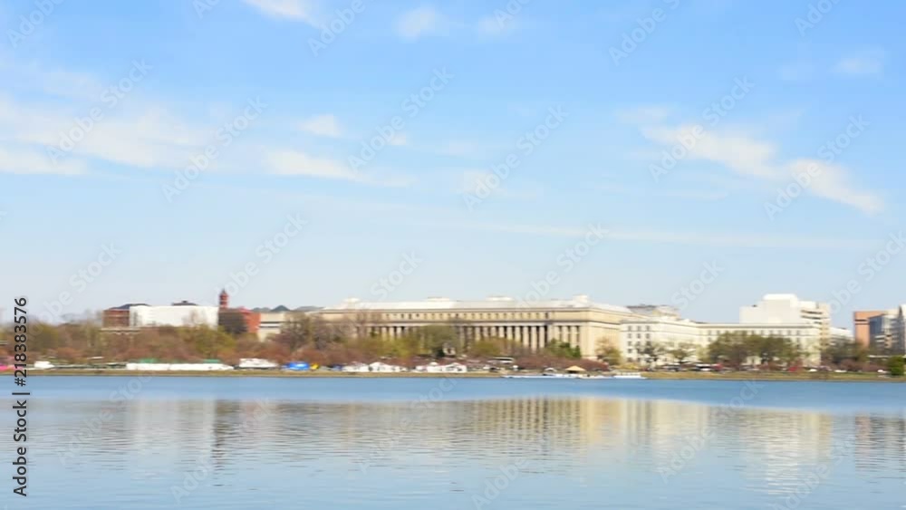 Panning Tidal Basin with Washington Monument in DC during cherry blossom festival, Jefferson Memorial