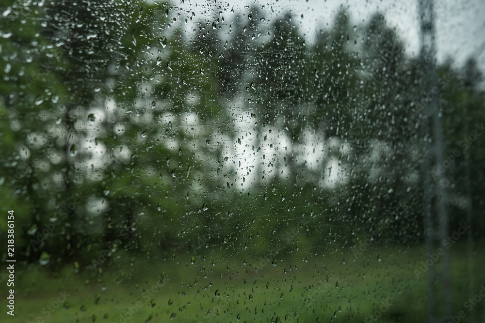 Obraz premium Drops on the glass on the train. On a long trip heavy rain