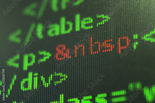 Programming code abstract screen of software developer. Computer script. close up on texture digital pixel is running primary code number with black background and selective focus.