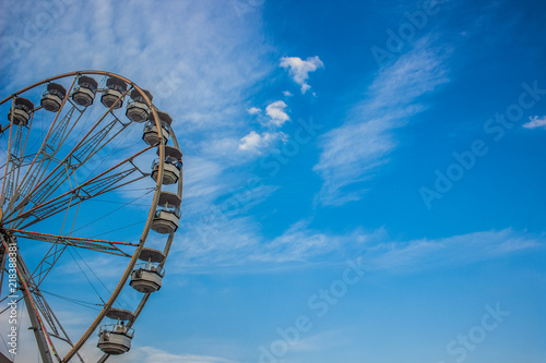 entertainment carnival concept of ferris wheel on blue sky cloud background with empty space for copy or text © Артём Князь