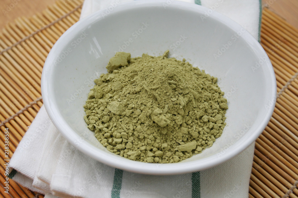 Green Matcha tea powder in a bowl on wooden background. Powdered matcha green tea on wooden table Green Matcha tea powder in a bowl on wooden background. Powdered matcha green tea on wooden table
