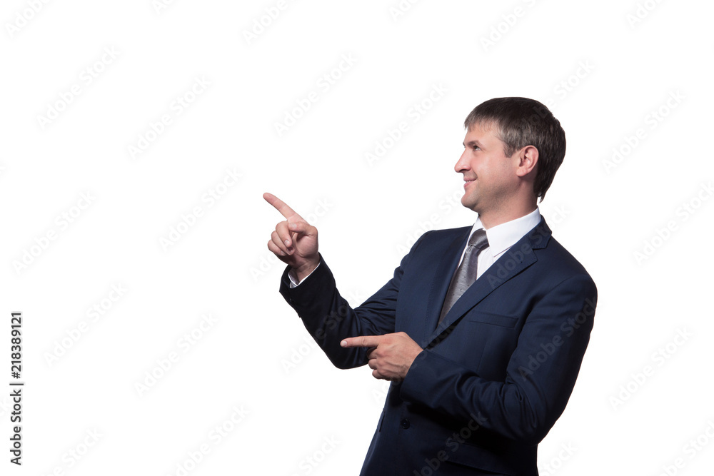 Young handsome businessman with beaming smile pointing with finger Young handsome businessman with beaming smile pointing with finger