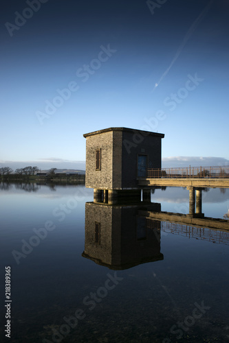 Building reflected into a loch
