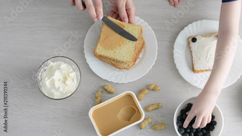Mother with kid making sweet toasts