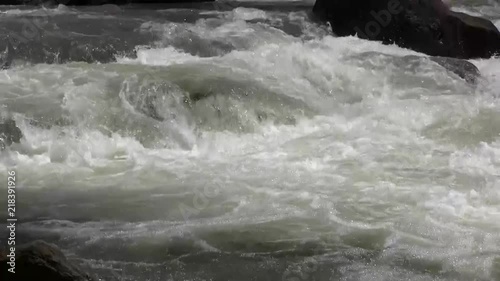 static shot of rushing water then zoom out