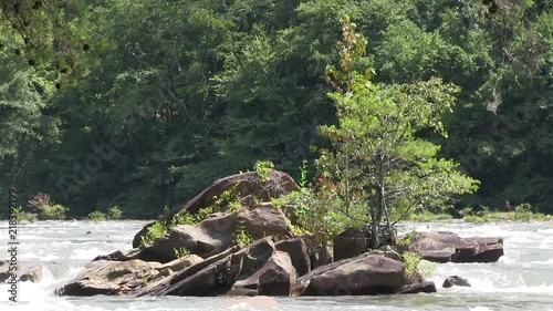 Rock island in the middle of a rushing river