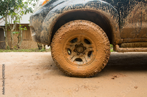 Closeup dirty Wheels in a countryside, Adventure background. Detail of dirty off-road car, Dirty offroad car side