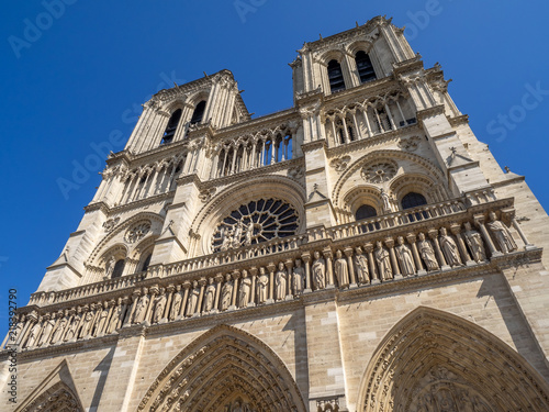 Looking up the exterior facade of Notre Dame de Paris cathedral in Paris France. 