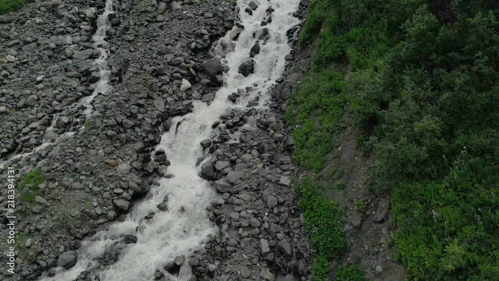 Rocky river and rocks in a mountainous airy landscape. Mountain river with large stones. View from the top flight over the river Rocky river and rocks in a mountainous airy landscape. Mountain river with large stones. View from the top flight over the river