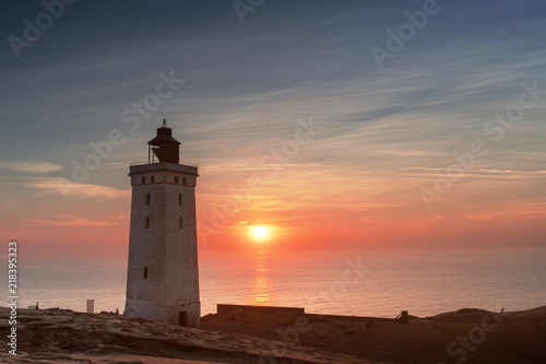 Beautiful sunset view of the lighthouse and sand desert dunes and ocean. Rubjerg Knude Lighthouse  L  nstrup in North Jutland in Denmark  Skagerrak  North Sea
