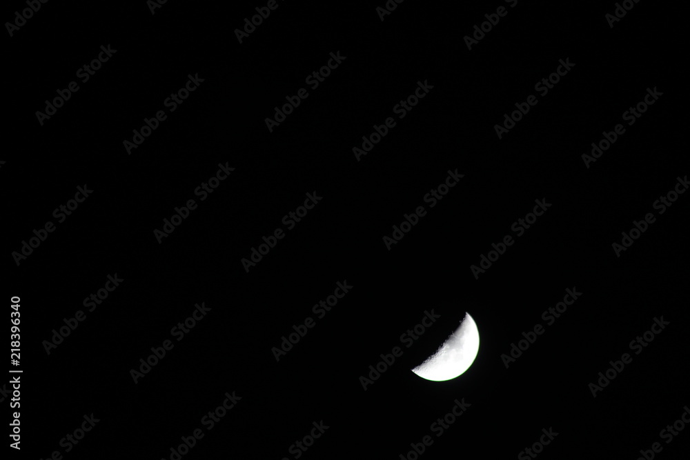 Crescent moon in the dark night with visible craters Crescent moon in the dark night with visible craters