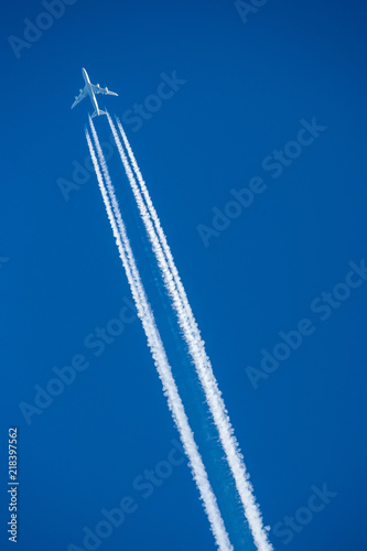 Aircraft flying at high altitude with contrails