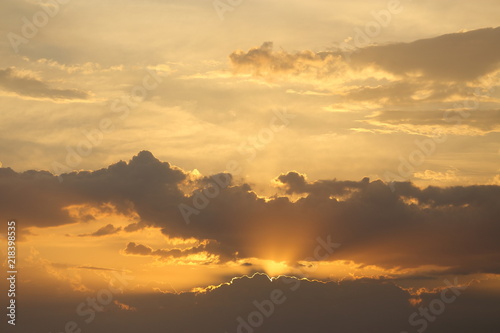 Beautiful sunset with clouds of orange and yellow in the ocean, the river